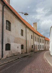 Deserted old city street suny day with paving stones