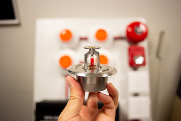 Fire alarm and mock sprinkler system attached to a white wall used for training - obrazy, fototapety, plakaty