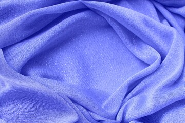 Fototapeta premium Light purple shiny fabric, folded in folds. Shiny knitwear, organza. Solid background.