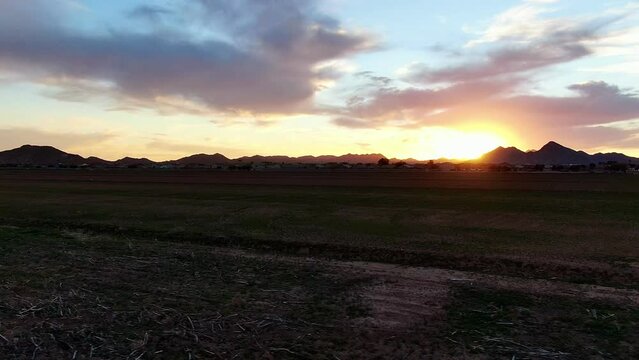 Sunset over a farm field. 