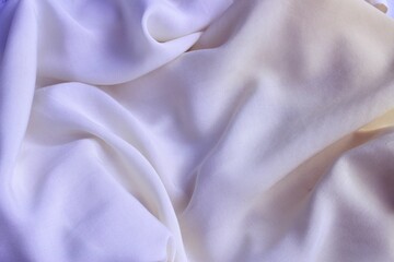 Obraz premium Plain light lilac fabric with beautiful pleats. Satin, linen, cotton or silk. Solid background.