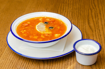 Solyanka with lemon and sour cream