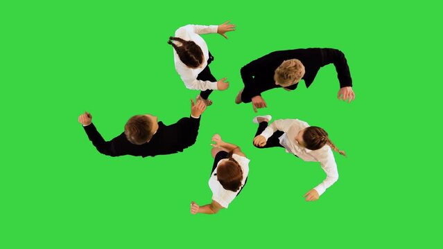 Dancing office workers synchronously put their hands in the center of imaginary circle on a Green Screen, Chroma Key.