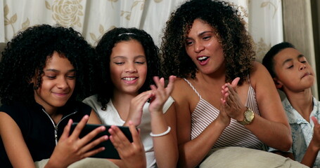 Brazilian mother and children talking to family member using tablet device at home