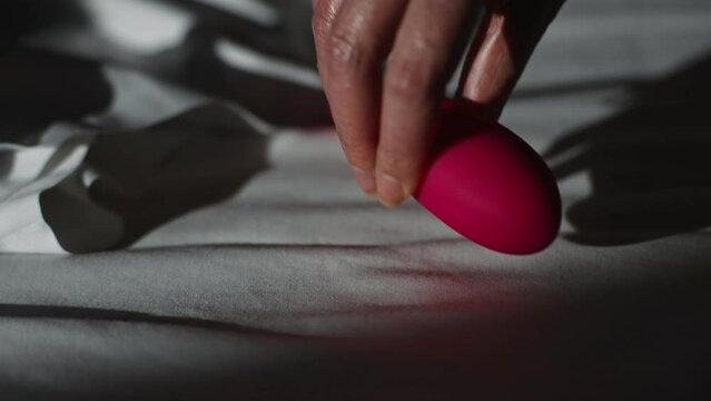 Woman taking pulse vibrating stimulator egg.
