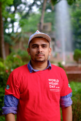 Naklejka na ściany i meble South asian young male medical student wearing red t shirt in awareness about world heart day campaign 