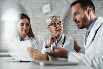 Group of doctors analyzing medical data while having a meeting in the office