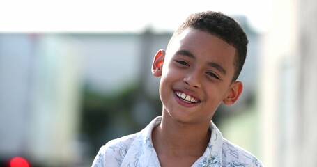 Brazilian little boy child smiling face close-up outside