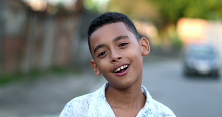 Brazilian boy child kid portrait face smiling outside in street