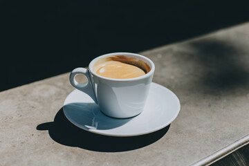 Cup of black coffee in a street cafe. Place for text.
