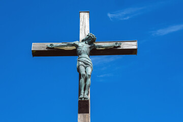 Statue of Christ on the cross against a blue sky