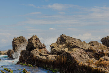 a large and long rock formation in Sawarna Beach, Indonesia