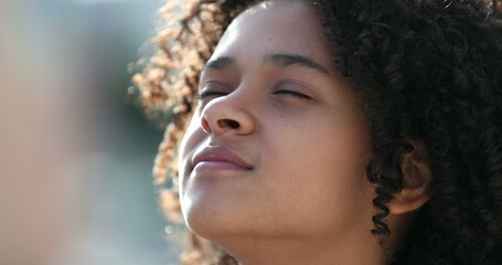 Black girl child closing eyes in meditation and contemplation