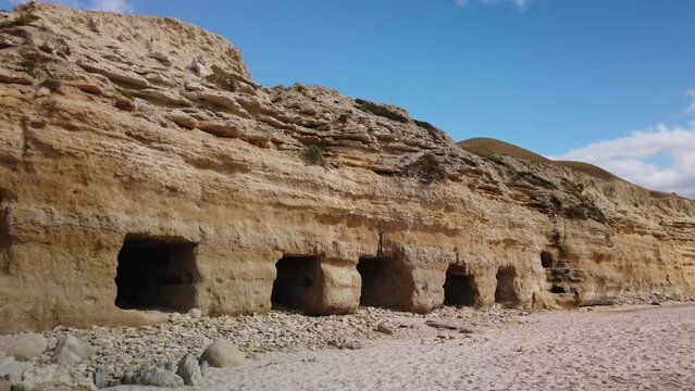 Port Willunga historic beach caves carved out by fisherman to store boats and nets, Right to left pan, Fleurieu Peninsula, South Australia,Australia