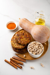 Stack pumpkin vegetables fritters pancakes cinnamon chick peas healthy food on light surface