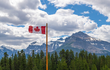 Flag of Canada in the Rocky Mountains of Banff national park, Alberta, Canada.