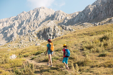 mother with a child on a hike walk along the road