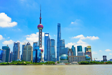 View of the skyline along the riverside on a sunny day in Shanghai, China.