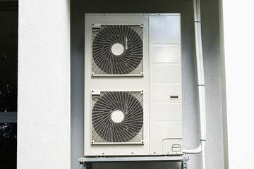 Heat pump or air conditioning outdoor unit in modern house of future using green electric energy, heat pump - efficient source of heat