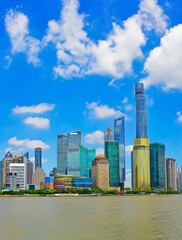 Obraz premium View of the skyline along the riverside on a sunny day in Shanghai, China.