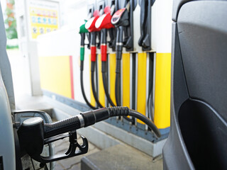 Car is filling up with diesel or petrol at petrol station, high prices of oil increases concept