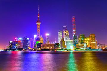 Fototapeta premium View of the skyline along the riverside at night in Shanghai, China.