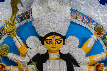 idol of goddess Durga during Durga Puja festival. Hindu deity in traditional white daker saj decorated attire. Durga puja is unesco approved heritage cultural festival in west bengal india. - obrazy, fototapety, plakaty