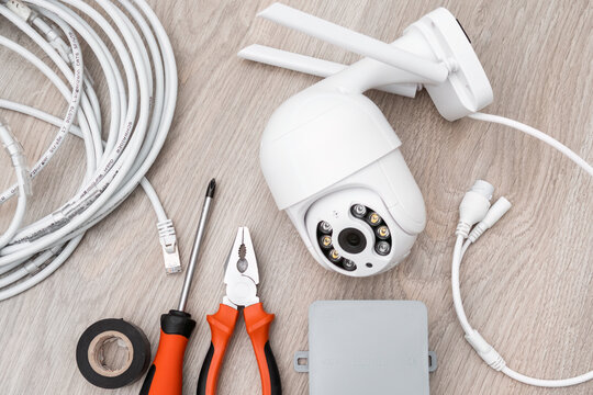 Instruments, cable, screwdriver and pliers for installation of intelligent IP CCTV camera on the table