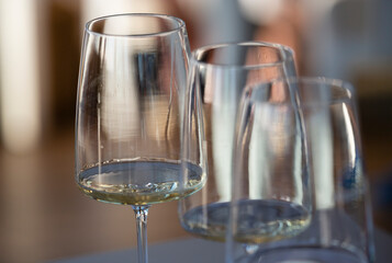 Three crystal glasses with white wine