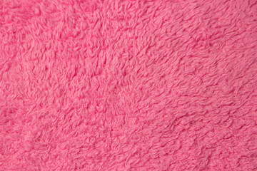 Texture of fluffy pink material as background for your image. Soft fabric surface