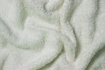 Texture of crumpled fluffy white material as a background for your image. Soft fabric surface