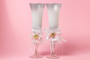 Festive champagne glasses on a pink background. Drink glasses
