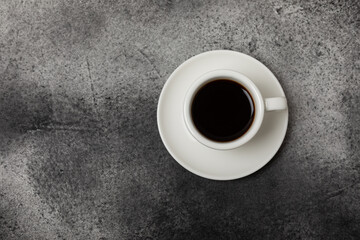 Cup of coffee on a dark background. Hot fragrant coffee on a textural background. Place for copy space.Place for text. Flat lay.