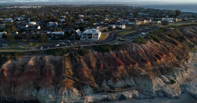 Sideway tracking from right to left aerial view of The Onkaparinga River and city of Port Noarlunga with wooden walkway leading to Noarlunga beach, Adelaide, South Australia,Australia