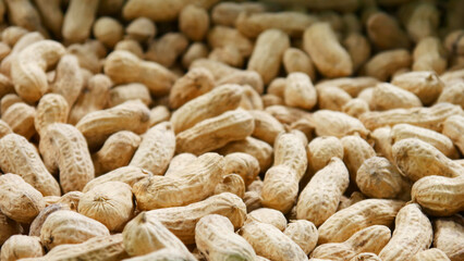 Close-up of a large pile of unpeeled peanuts