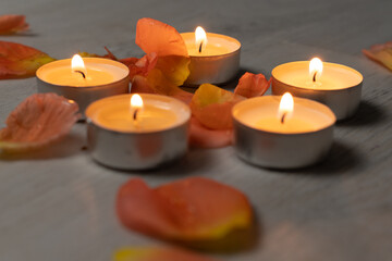 Fototapeta na wymiar A set of candles and rose petals, Aromatherapy and relaxation at the spa and at home.
