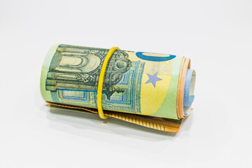 Roll of Euro notes in the elastic band. EU banknotes in a money roll. Organized crime concept