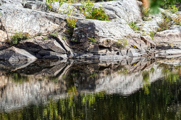 Fototapeta na wymiar Hard to define boundaries between rocks and water , Thunder Bay, ON, Canada