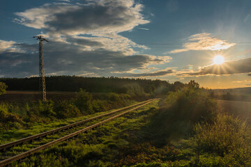 Old non electrified railway track near Rakovnik town in sunset evening