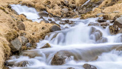 A cascade of a river flowing through a field