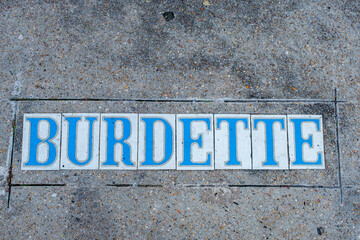 Vintage sidewalk tile inlay for Burdette Street in Uptown New Orleans neighborhood