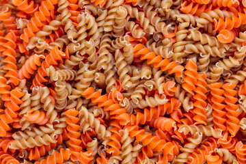 Whole, lentils fusilli pasta background.
