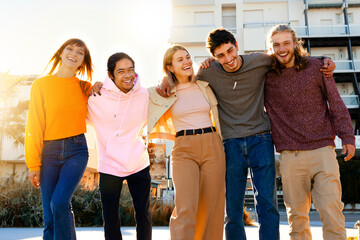 Group of happy multiracial  friends  smiling  walking outdors- University  student teenarges  at...