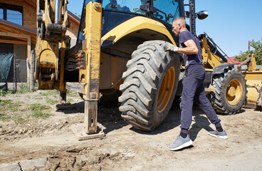 Mechanic changing tire on the bulldozer © GeorgeCosmin