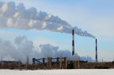 Pipes of plant pollute environment with harmful gases, exhausts. Concept of ecology, nature protection, climate warming.