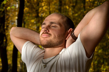 Fototapeta premium candid portrait of a strong young man in sunlight