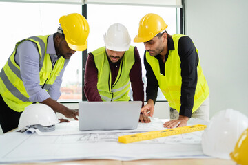 Architectural engineers lay hands on the construction site, meeting, discussing, designing, planning a construction project. Successful engineer. The concept of working as a team. Real estate.