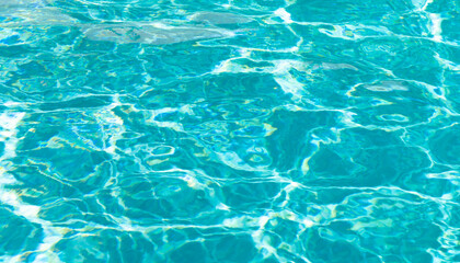Fototapeta na wymiar turquoise color background of swimming pool water with ripples in summertime