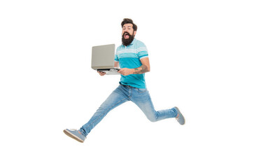 Excited man midair isolated on white. Bearded man jumping with laptop. Energetic man computing