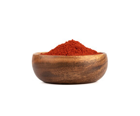 Wooden bowl with red smoked paprika on a white background.
